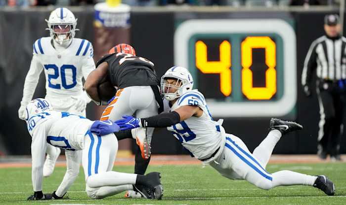 Indianapolis Colts linebacker Cameron McGrone (59) works to bring down Cincinnati Bengals running back Joe Mixon (28) on Sunday, Dec. 10, 2023, during a game against the Cincinnati Bengals at Paycor Stadium in Cincinnati.
